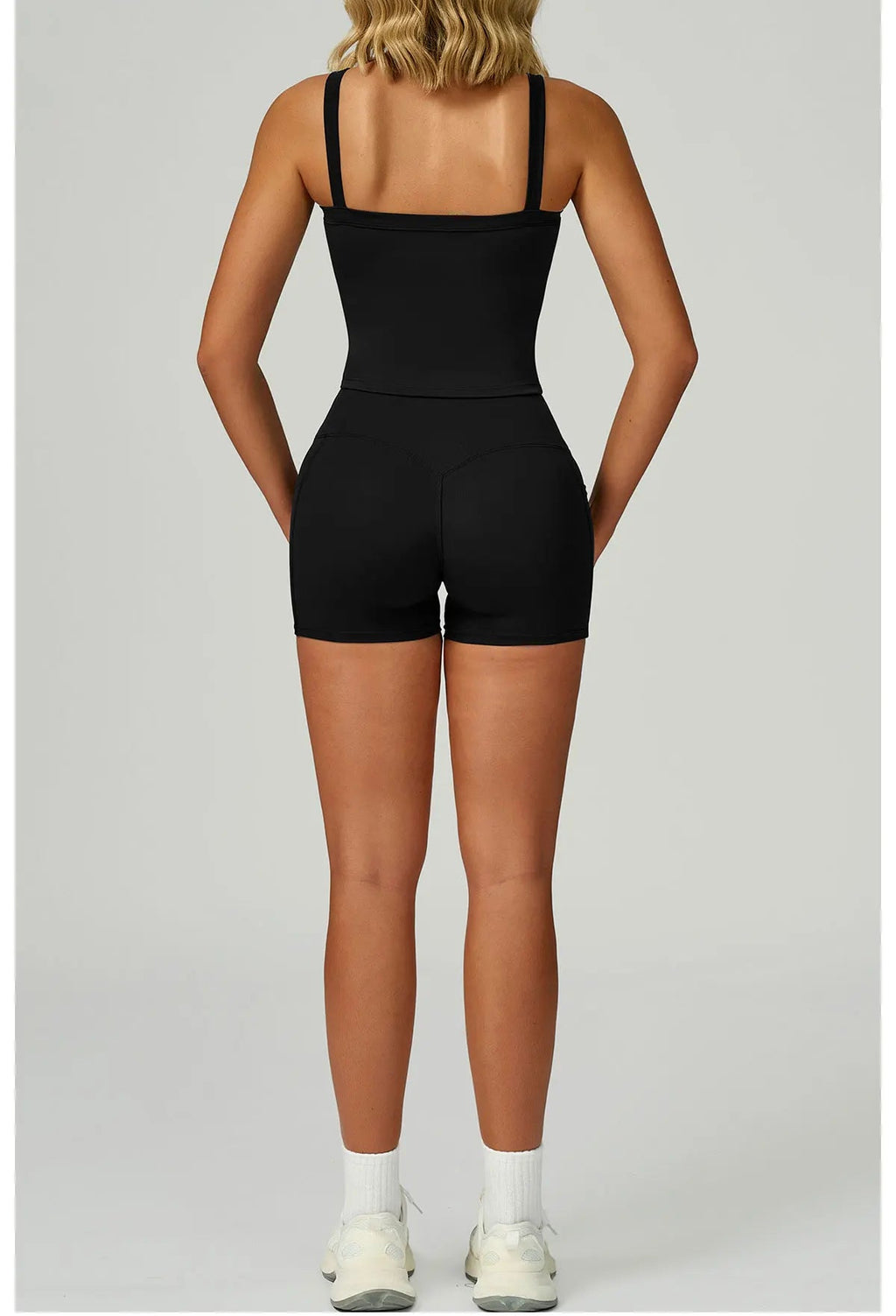 Black set back view: spaghetti-strap tank and fitted high-waist shorts