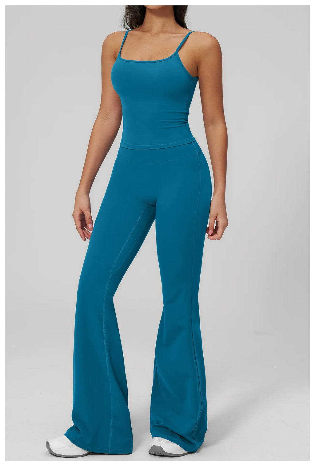 Women's peacock blue sports set, full-length front view: supportive tank and flared leggings
