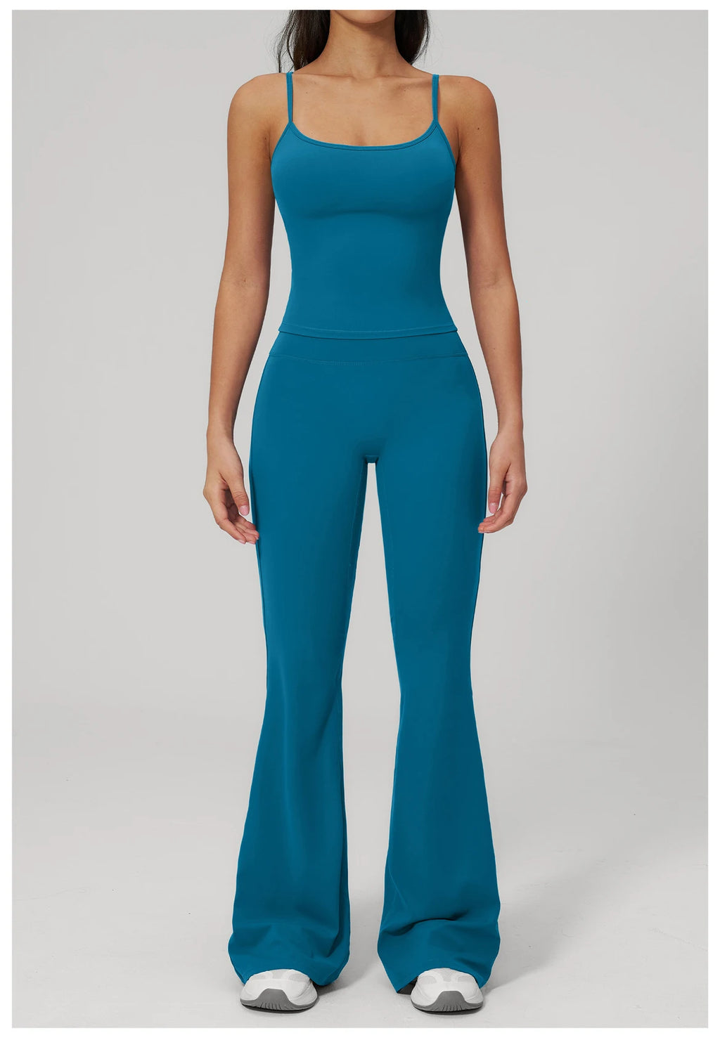 Women's peacock blue sports set, front view: tank top and flared leggings with built-in bra
