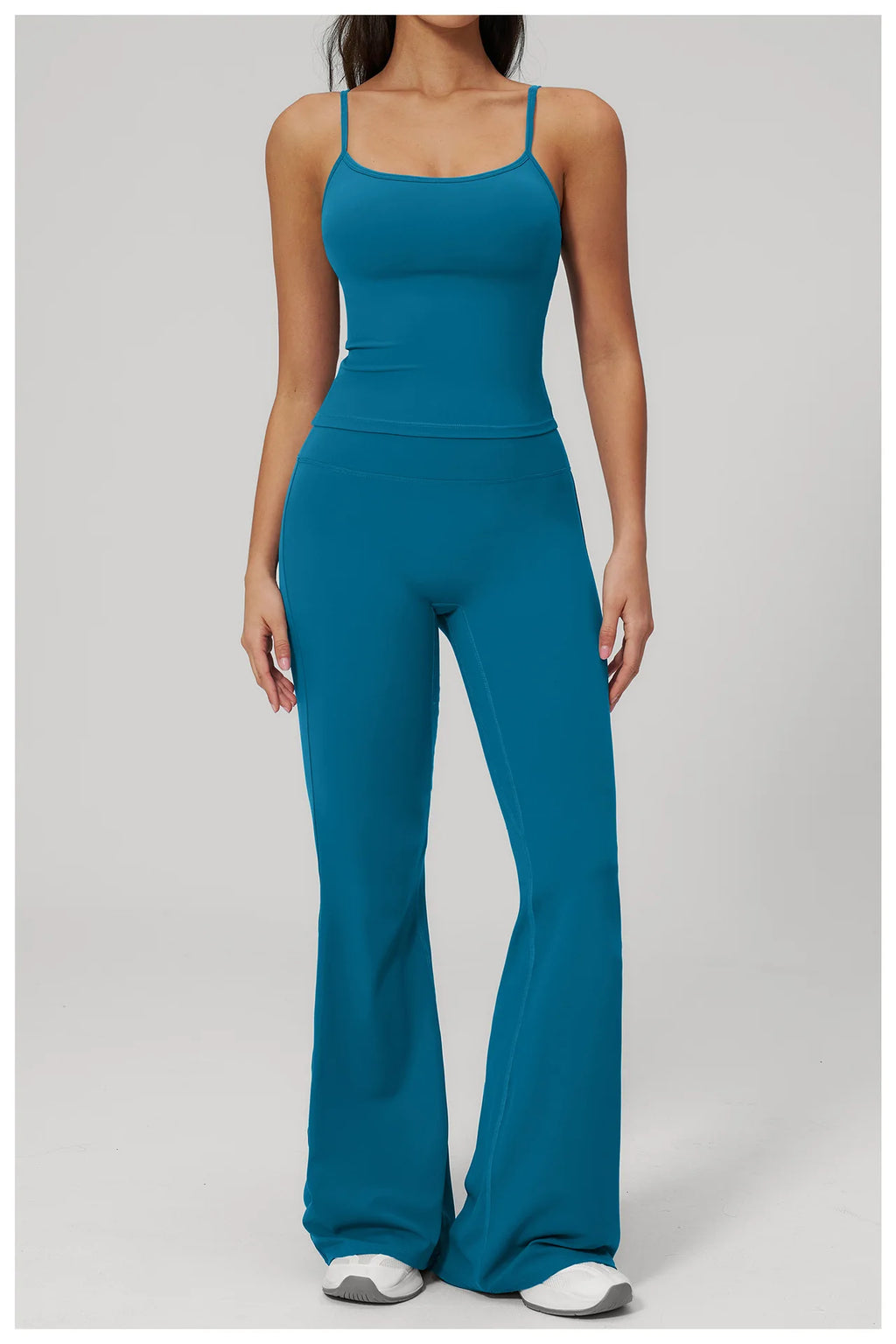 Women's peacock blue sports set, front view: fitted tank and flared leggings