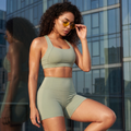 Sage green sports bra and high-waist shorts matching set, clean neckline