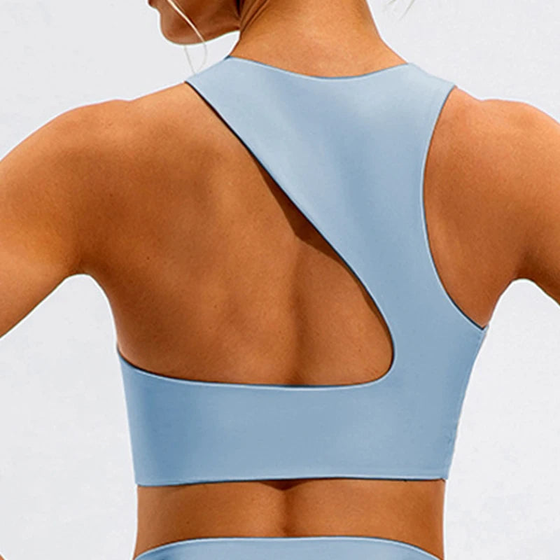 Xooie Fit unique open-back bralette in light blue showing stylish asymmetrical back design