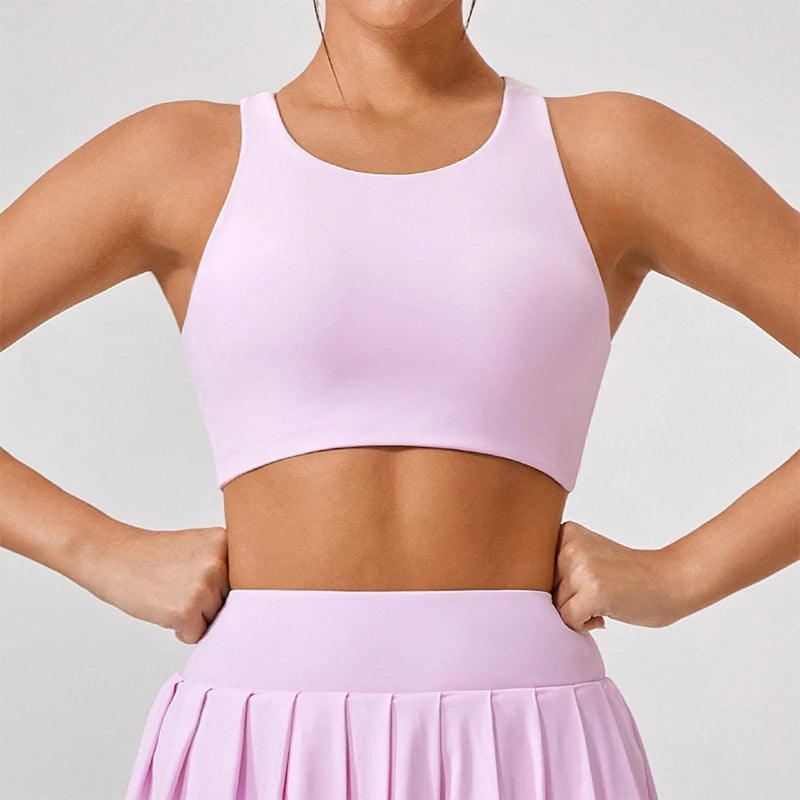 Xooie Fit light pink unique open-back bralette with wide straps and smooth fabric on model