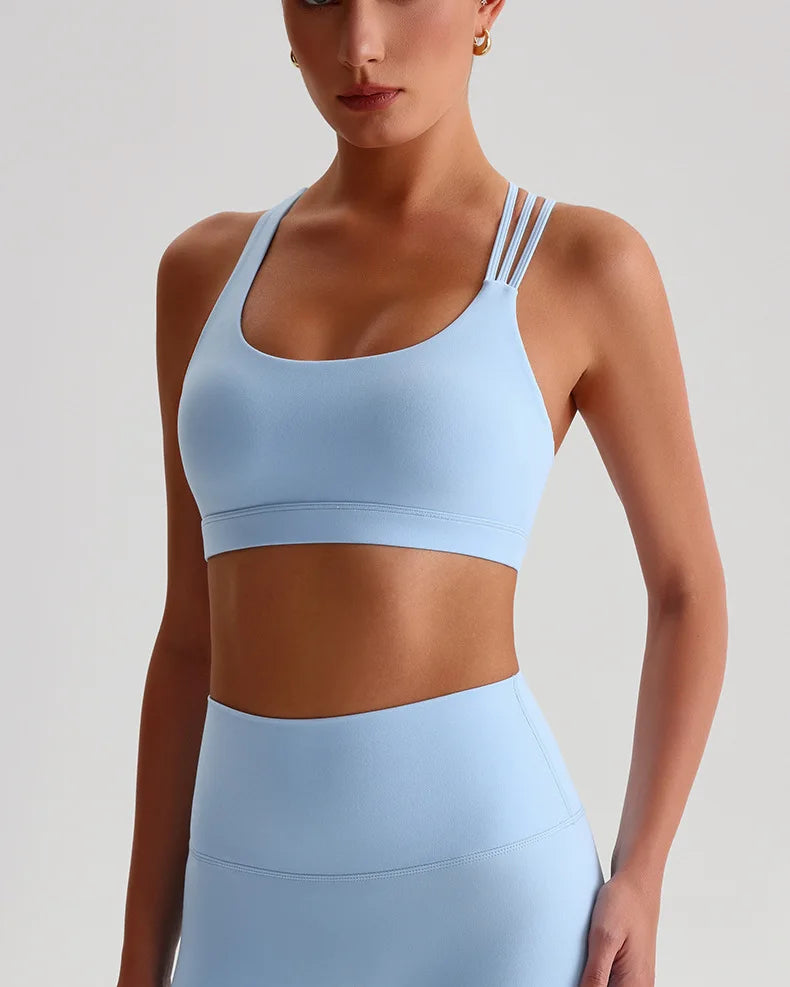 Unique strappy sports bra for women in light blue with stylish straps and comfortable fit