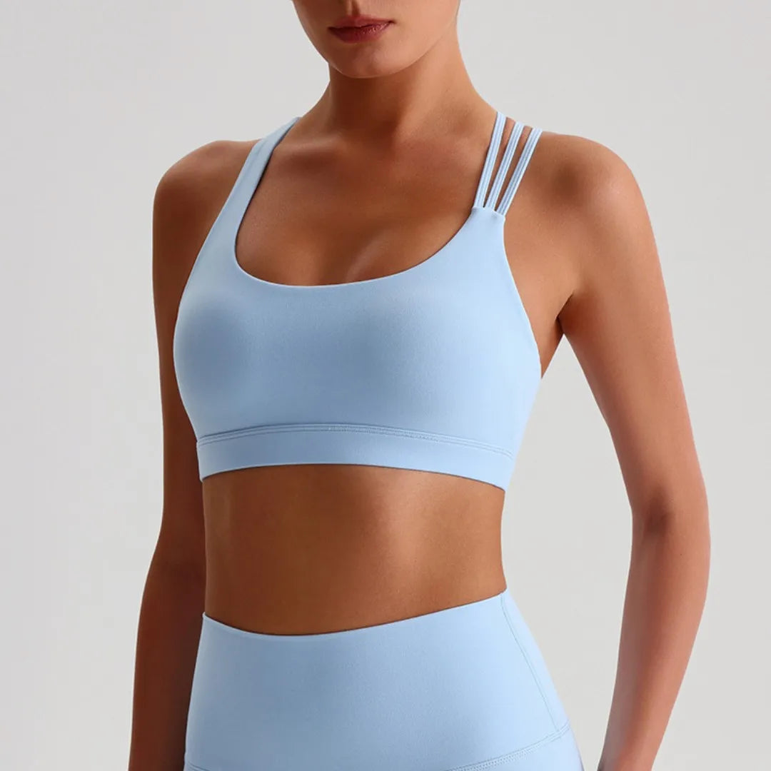 Light blue unique strappy sports bra for women with stylish strap design and comfortable fit