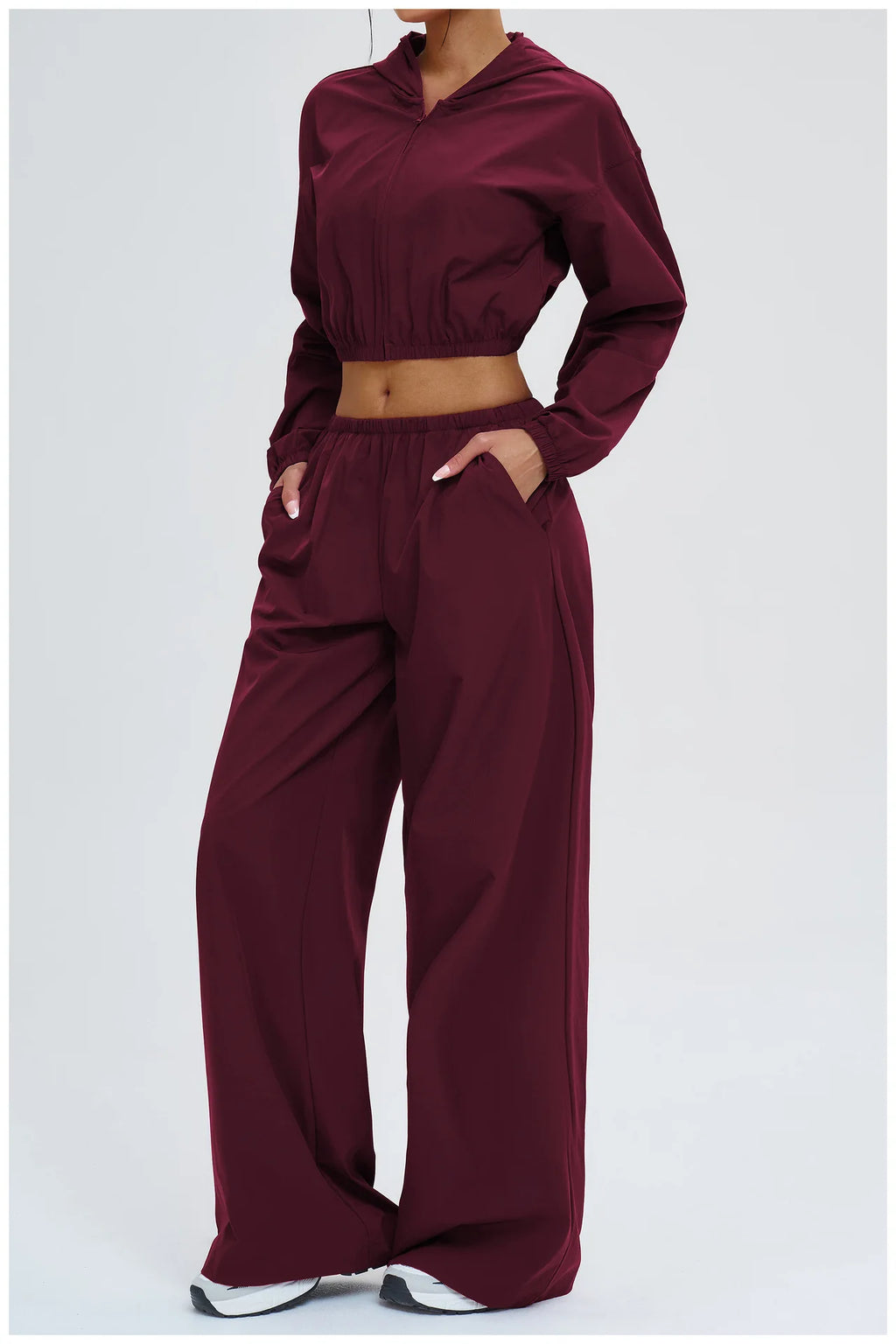 Burgundy high-waist wide-leg pants with gathered waistband and side pockets