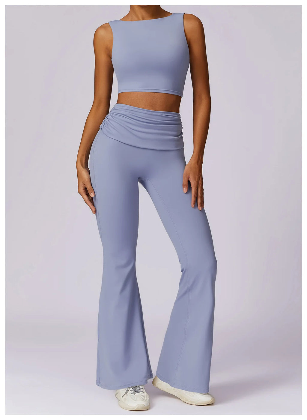 Light blue sleeveless sports bra crop top paired with matching wide-leg leggings.