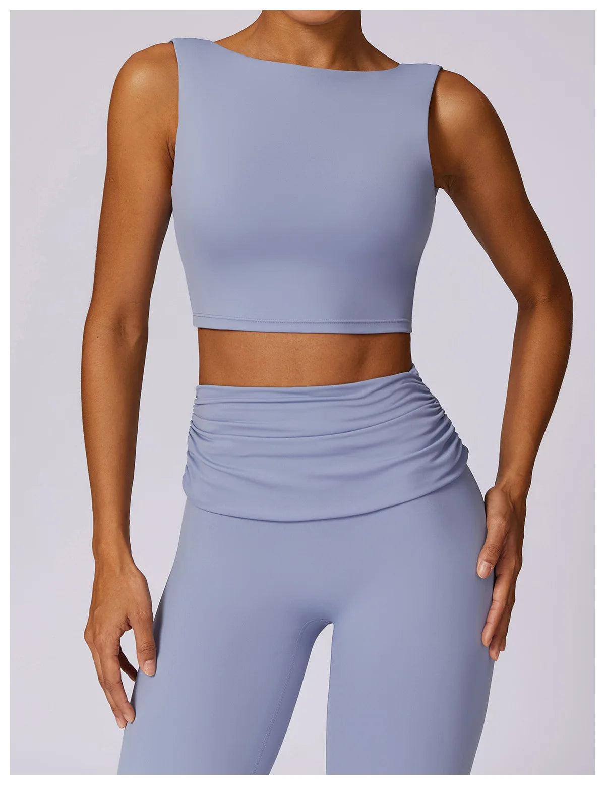 Light blue sleeveless sports bra crop top with high-stretch fit and smooth front.