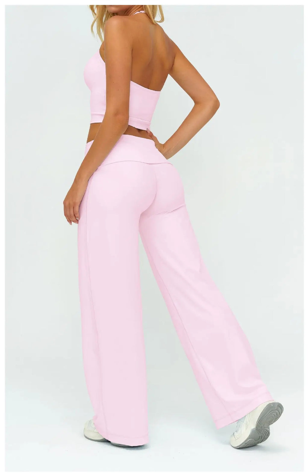 Light pink wide-leg flare pants with waist flap detail, full side view