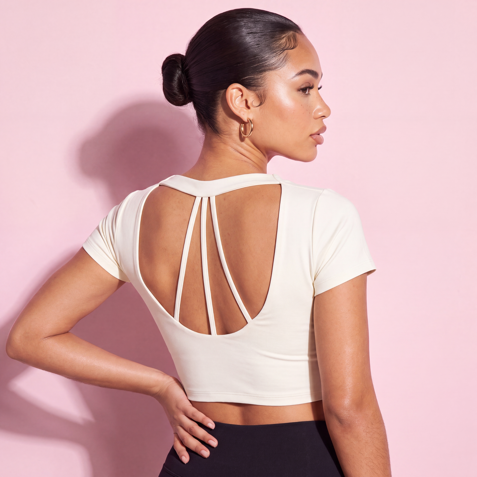 White short-sleeve crop top with open back and crisscross strap detail