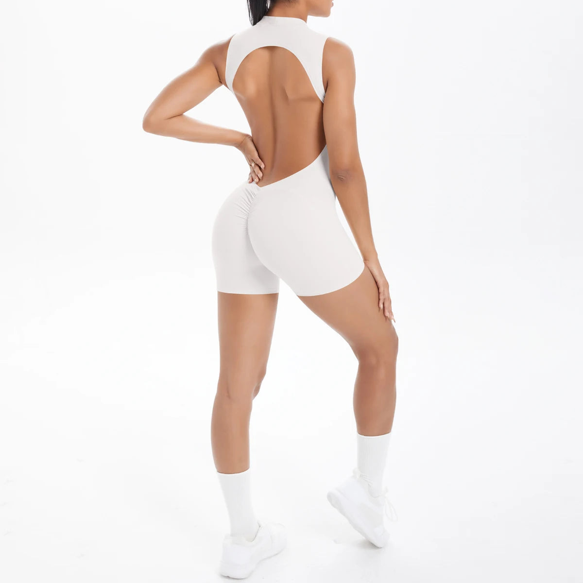 Xooie Fit backless active romper for women in beige, designed for style and comfort during workouts