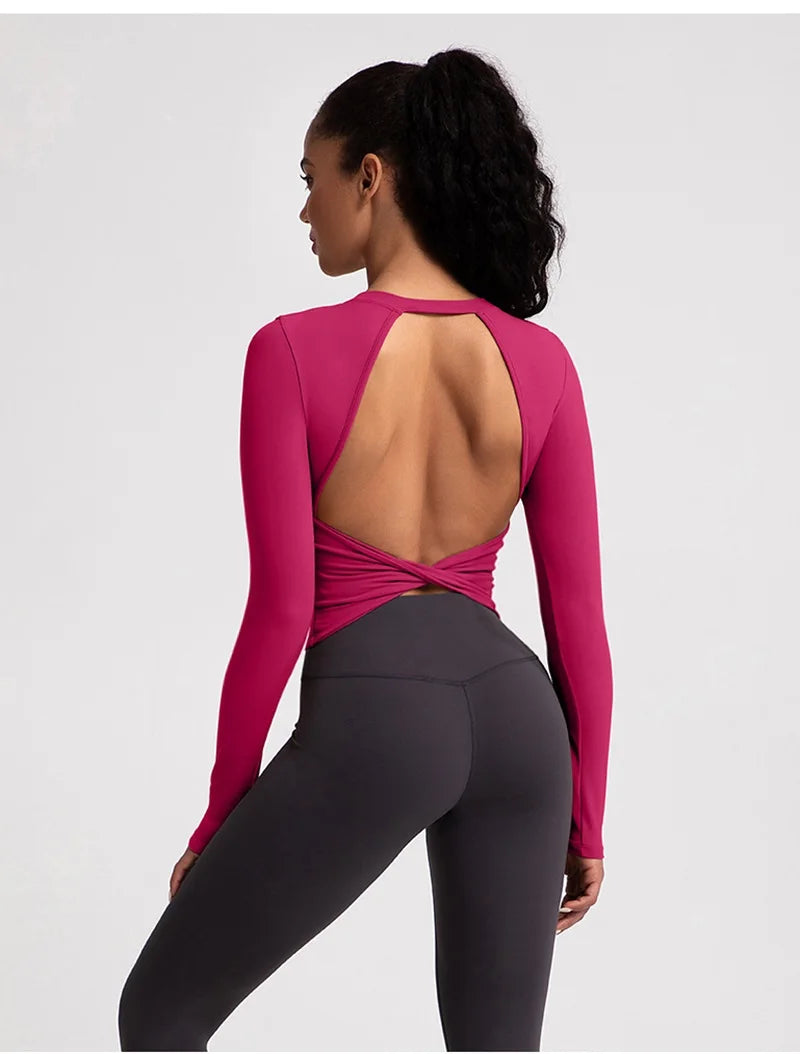 Xooie Fit backless long sleeve workout crop top in pink with stylish crossover back design