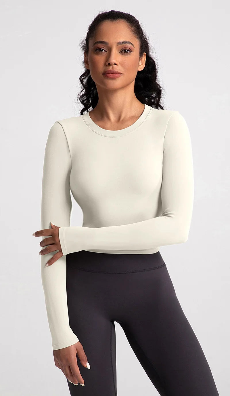 Xooie Fit backless long sleeve workout crop top in soft cream color for stylish gym wear