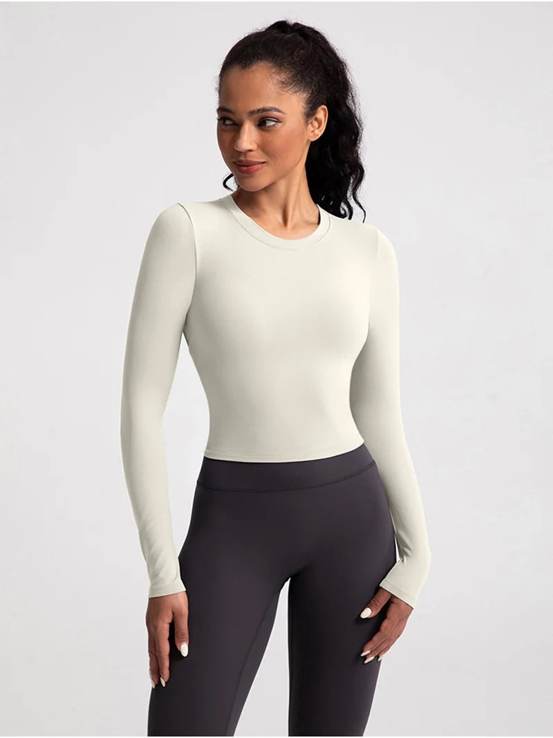 Xooie Fit backless long sleeve workout crop top in light color perfect for activewear.