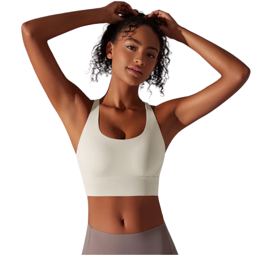 Xooie Fit criss-cross back sports bra in light color for comfortable support during workouts