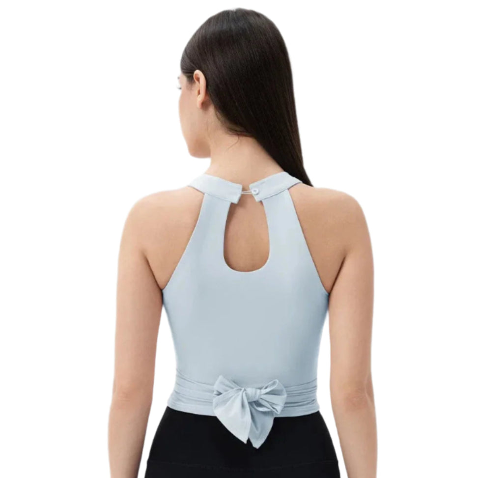 Back view of Xooie Fit Fitted Workout Top for Women in light blue with bow detail