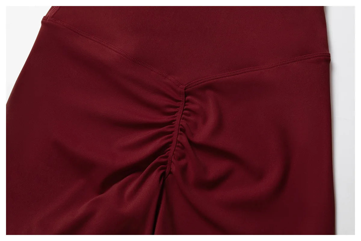 Close-up of maroon Xooie Fit flare pants showcasing ruched design for a flare pants and bra workout outfit