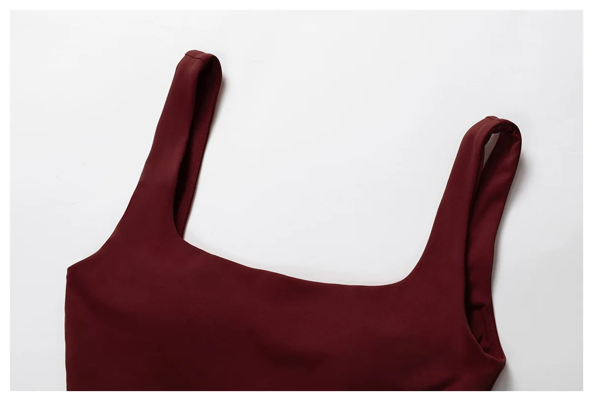 Close-up of a burgundy top from Xooie Fit as part of a flare pants and bra workout outfit