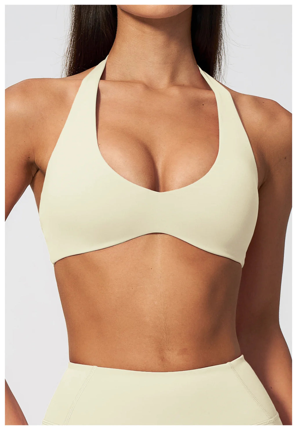 Creamy white halter yoga bra with deep V neckline and open back design