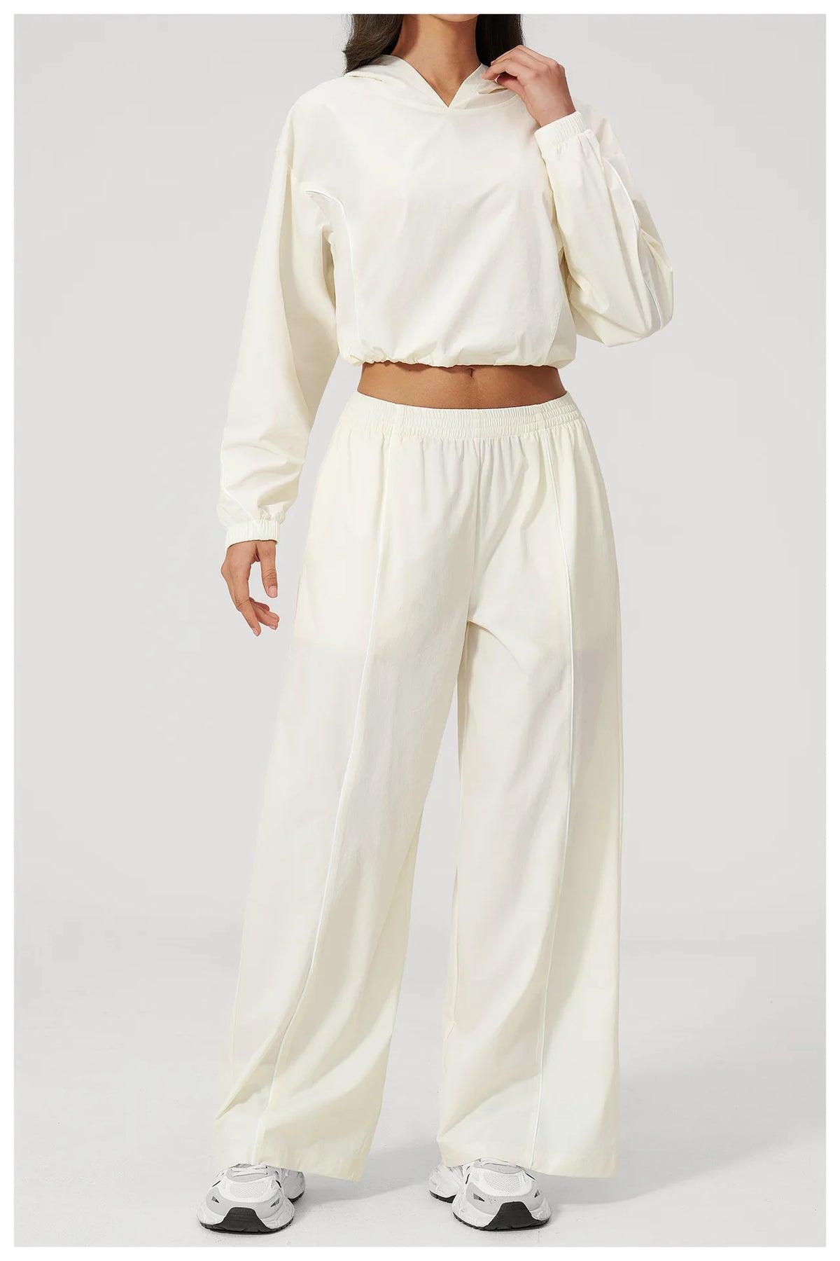 Women’s cream hooded windbreaker crop top and wide-leg pants set, side/front view