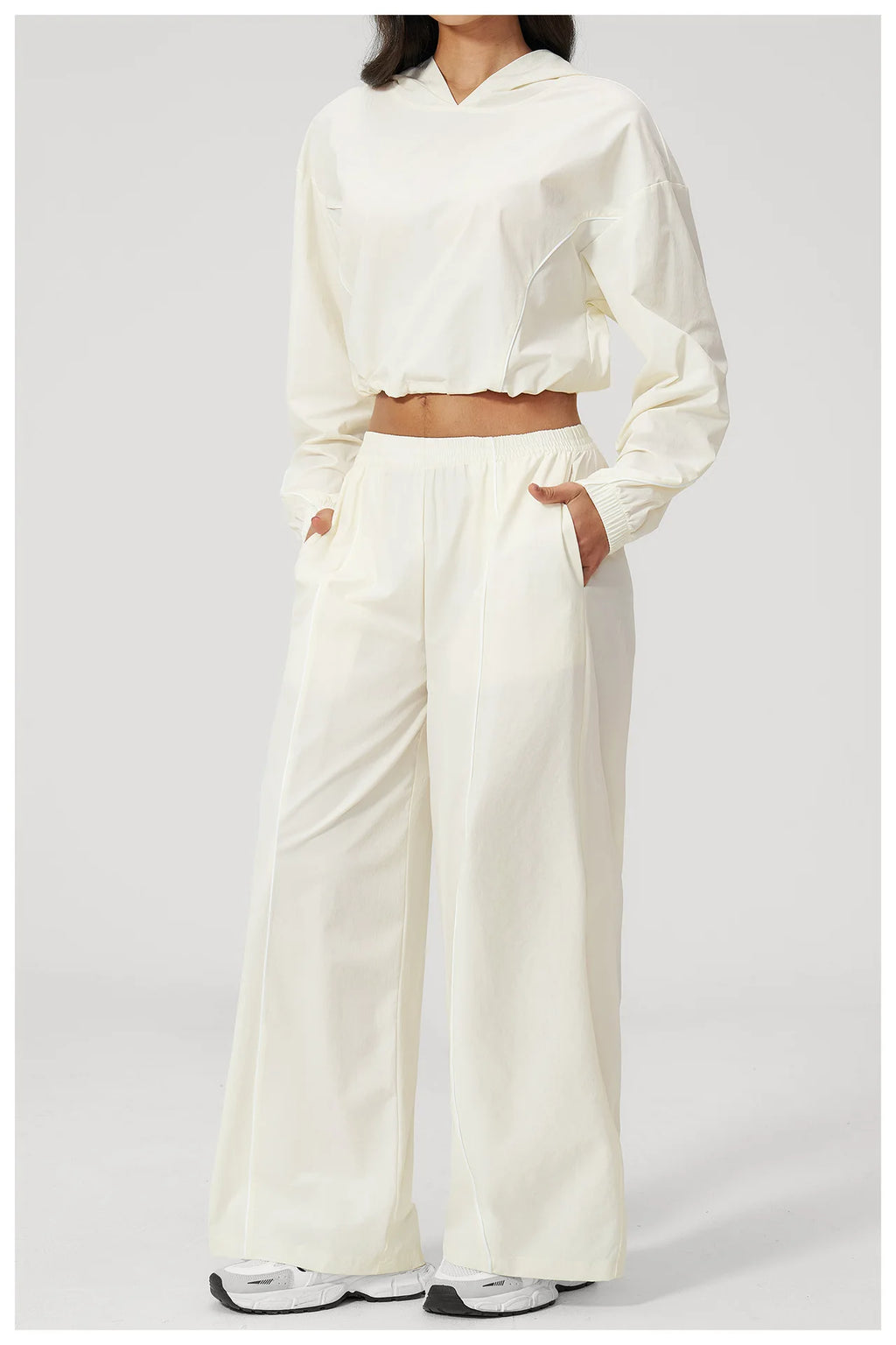 Women’s cream hooded windbreaker crop top and wide-leg pants set, front view
