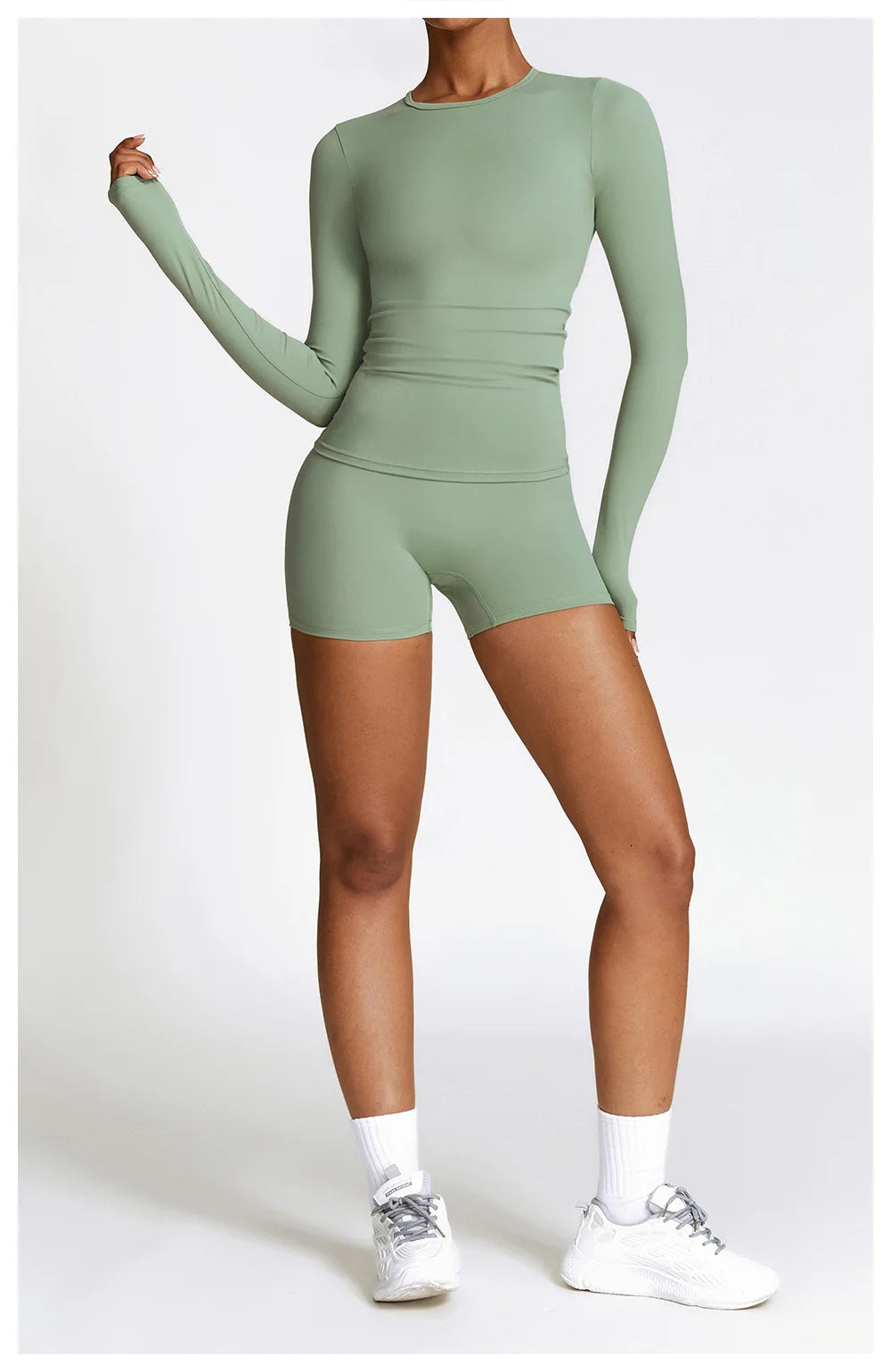 Xooie Fit long sleeve workout outfit in green featuring a fitted top and shorts for comfortable exercise