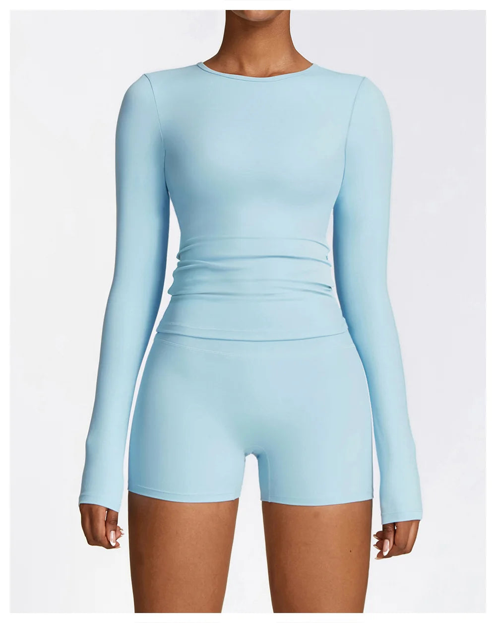 Xooie Fit long sleeve workout outfit in light blue featuring a fitted top and shorts for comfort