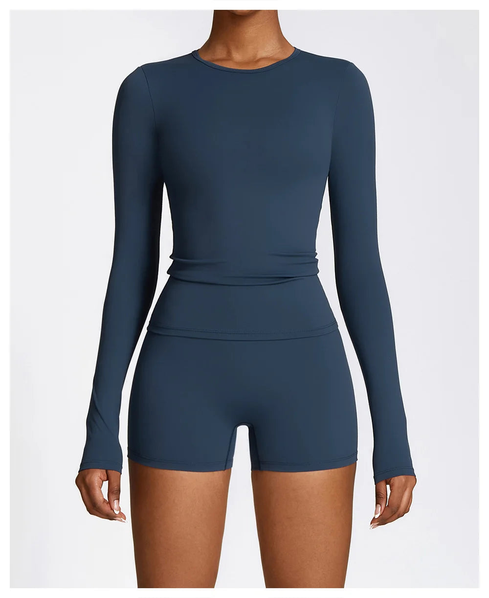 Xooie Fit long sleeve workout outfit in blue featuring a fitted top and coordinating shorts