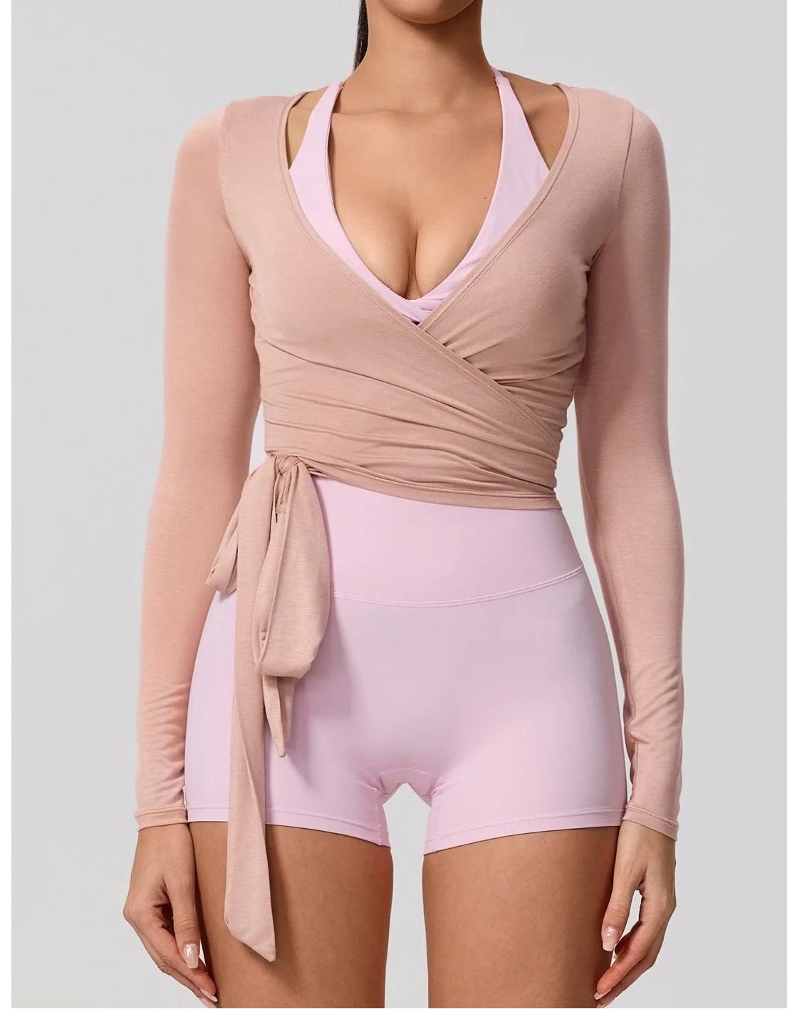 Xooie Fit long sleeve wrap top in soft pink, designed for a stylish and comfortable fit