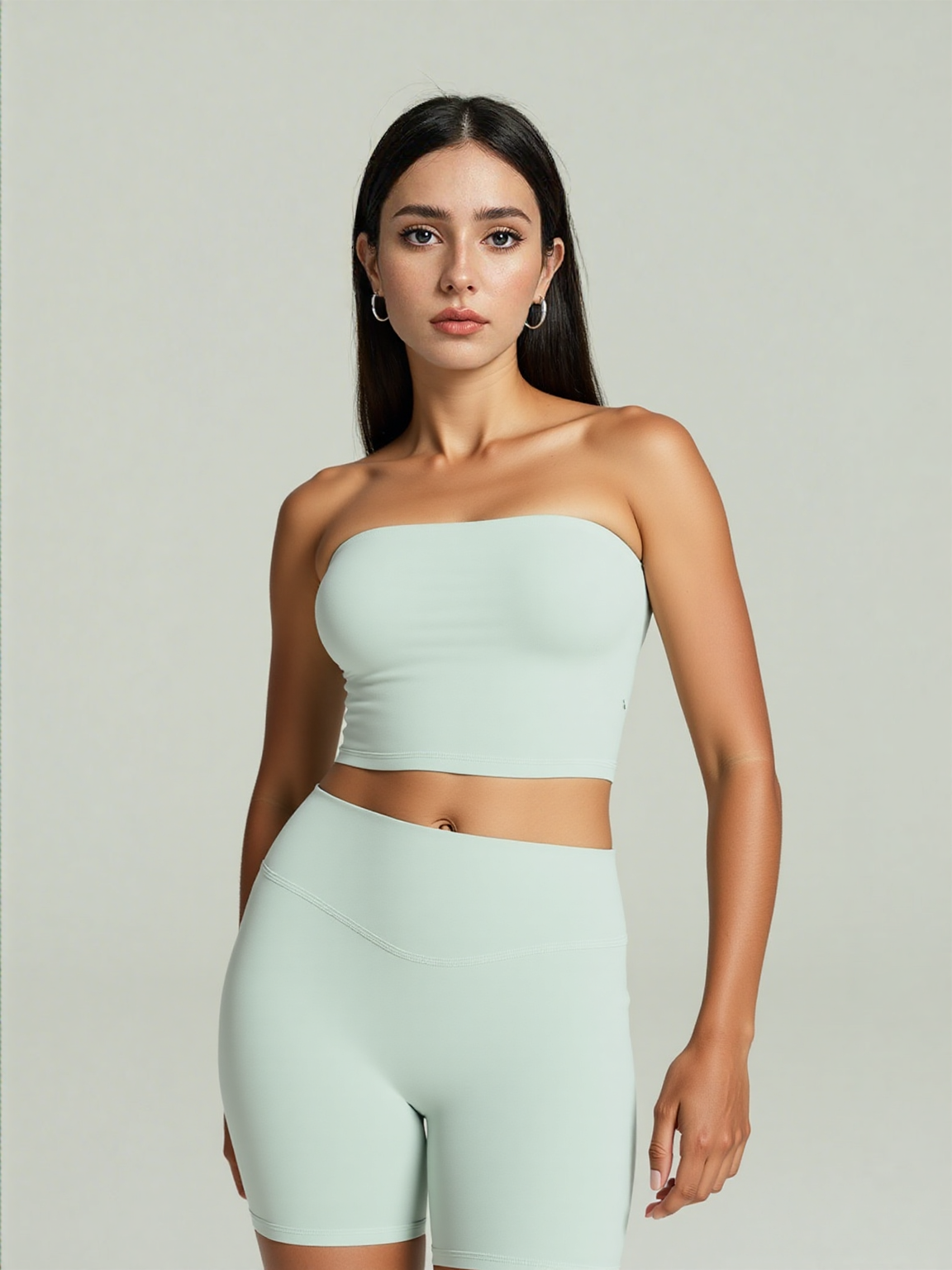 Xooie Fit strapless activewear set in light green featuring a fitted crop top and high-waisted shorts.