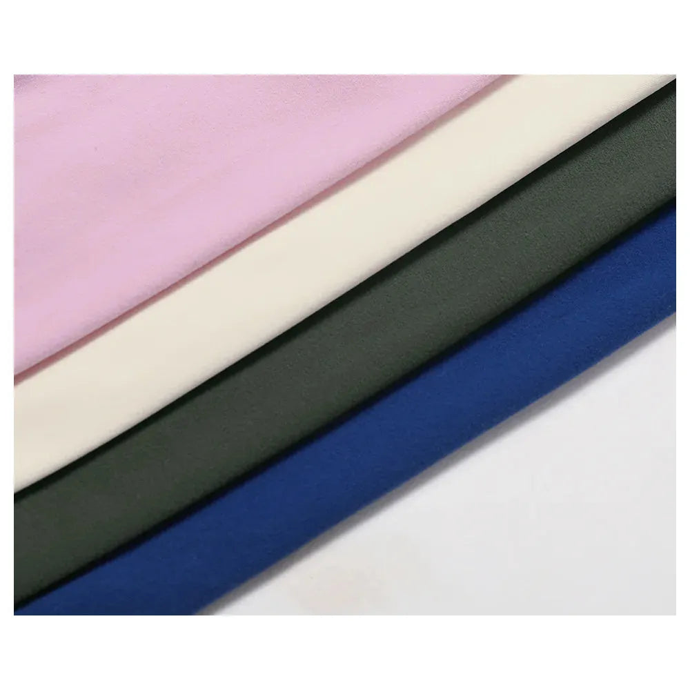 Four colors of Xooie Fit strapless sports bra fabric samples including pink, cream, green, and blue