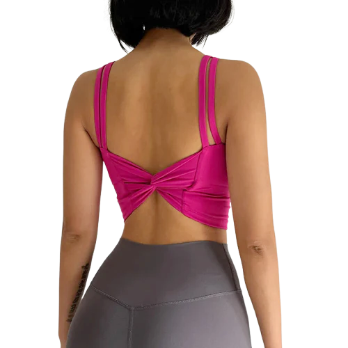 Back view of a stylish fitness bra by Xooie Fit in vibrant pink with a bow detail