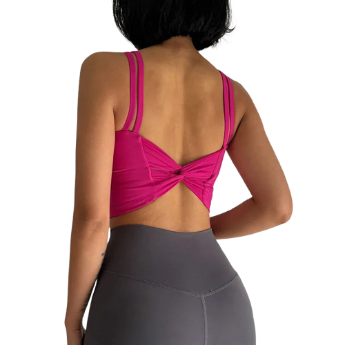 Back view of a stylish fitness bra from Xooie Fit in vibrant pink with a twisted design