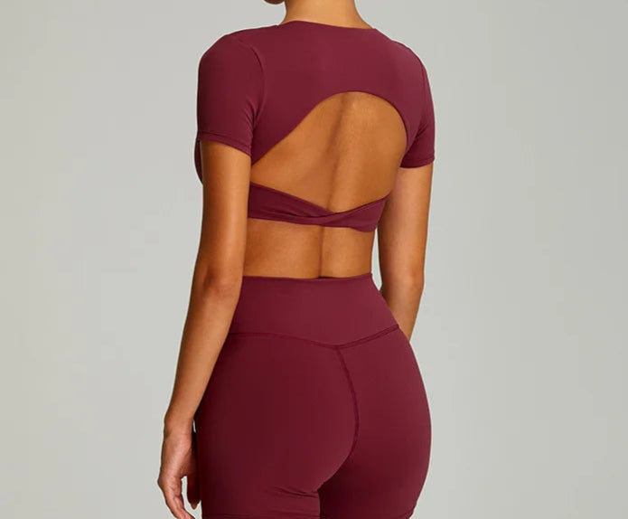 Xooie Fit twist crop top and leggings outfit in burgundy with stylish open back design