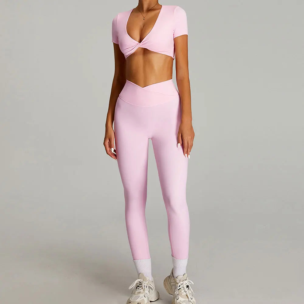 Xooie Fit twist crop top and leggings outfit in pink for stylish workout sessions.