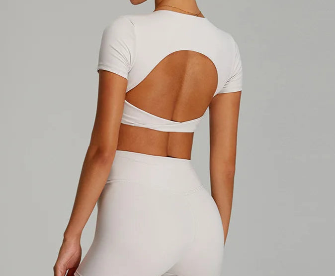 Xooie Fit twist crop top and leggings outfit in white with open back design for a stylish look