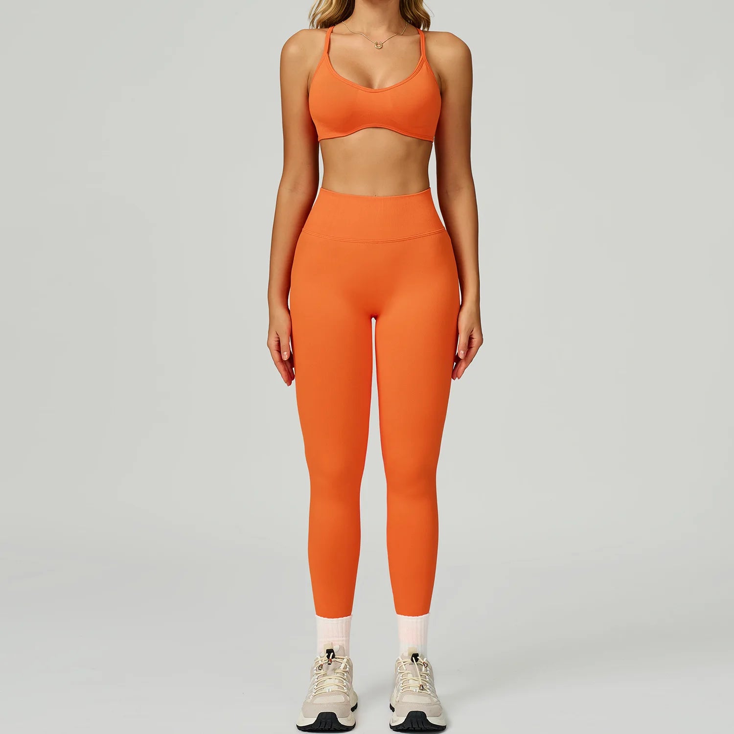 Xooie Fit women's activewear set in bright orange with a stylish crop top and high-waisted leggings