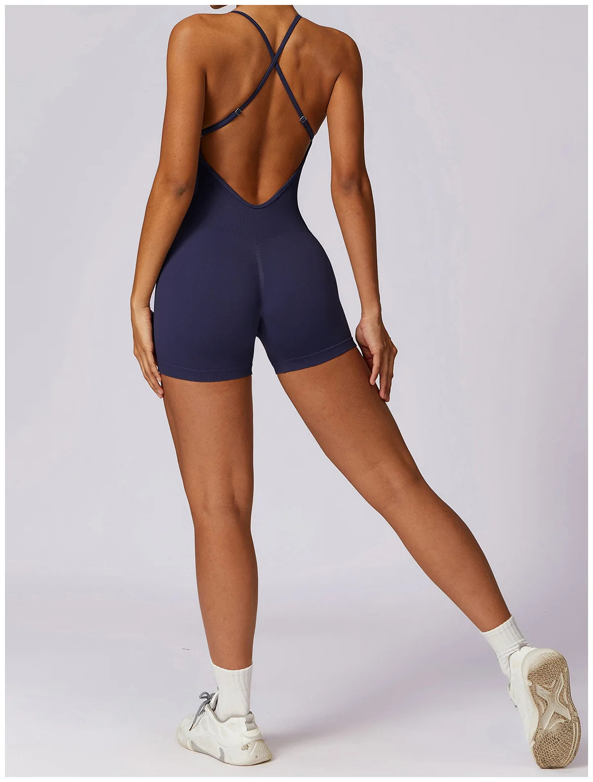 Xooie Fit Women's Fitness One-Piece in navy blue with a stylish back design for comfortable workouts