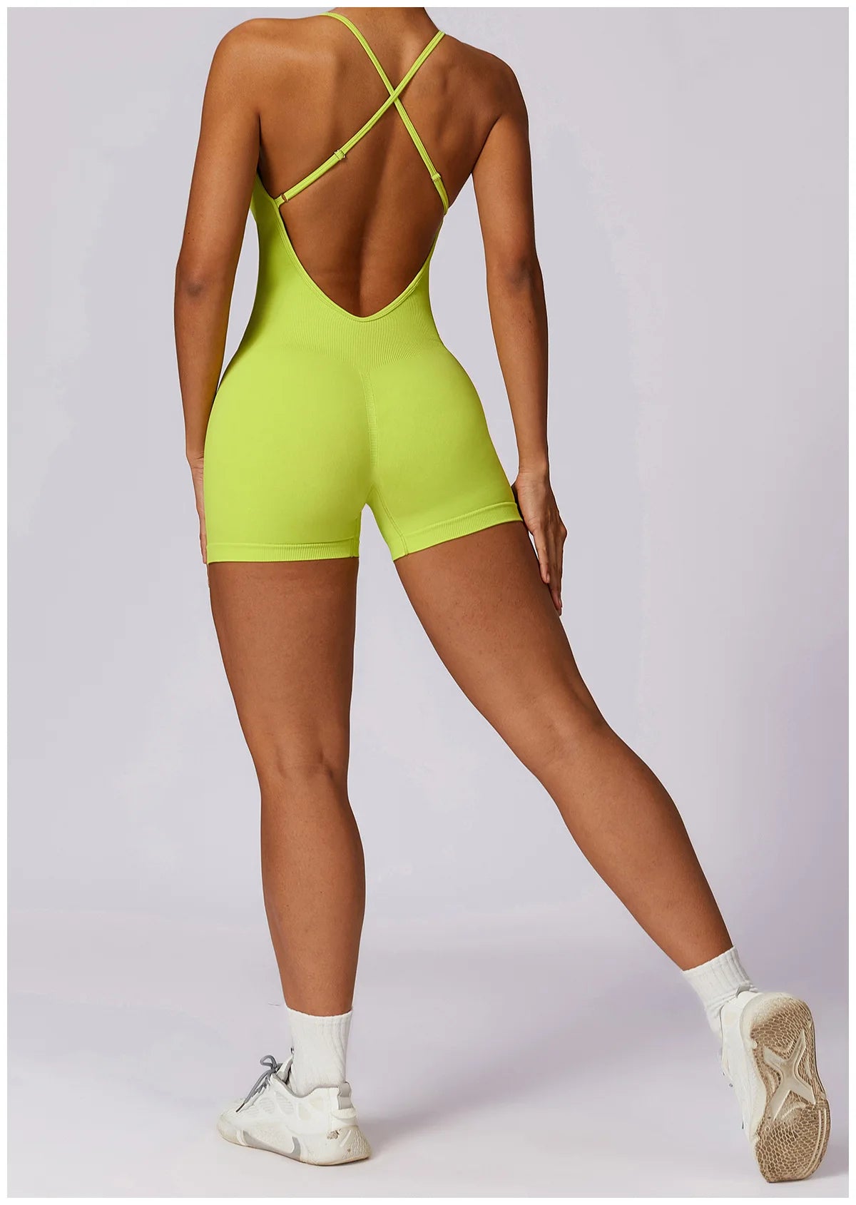 Xooie Fit women's fitness one-piece in neon green featuring a stylish back design