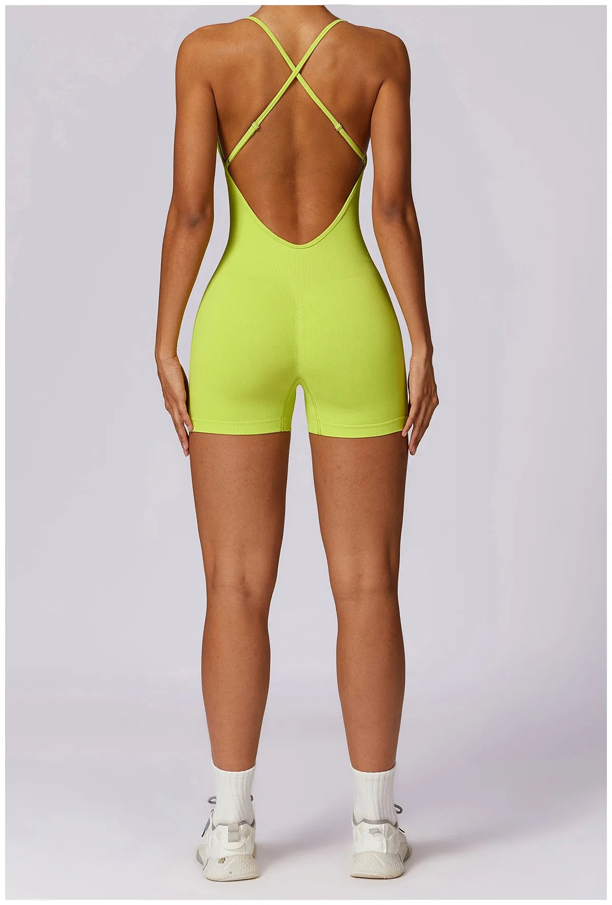 Xooie Fit women's fitness one-piece in vibrant neon yellow with crisscross straps