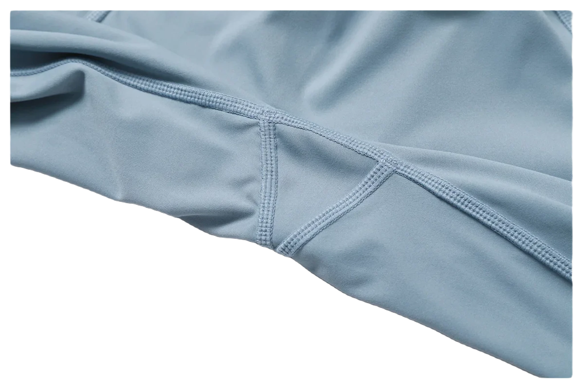 Soft blue fabric detail of Xooie Fit women's fitness two-piece set with reinforced stitching