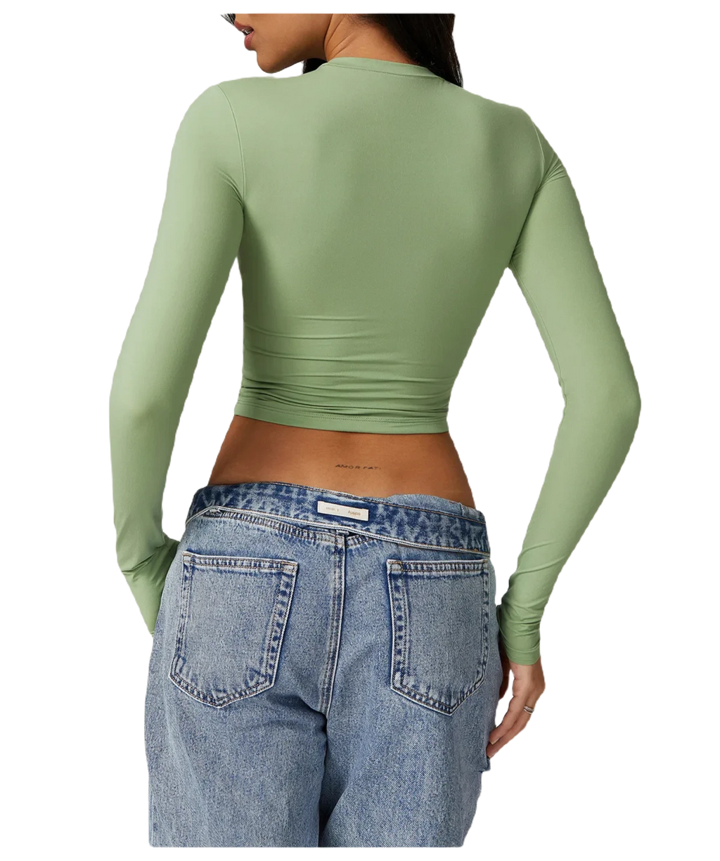 Xooie Fit women's fitted long-sleeve shirt in green, paired with high-waisted denim jeans