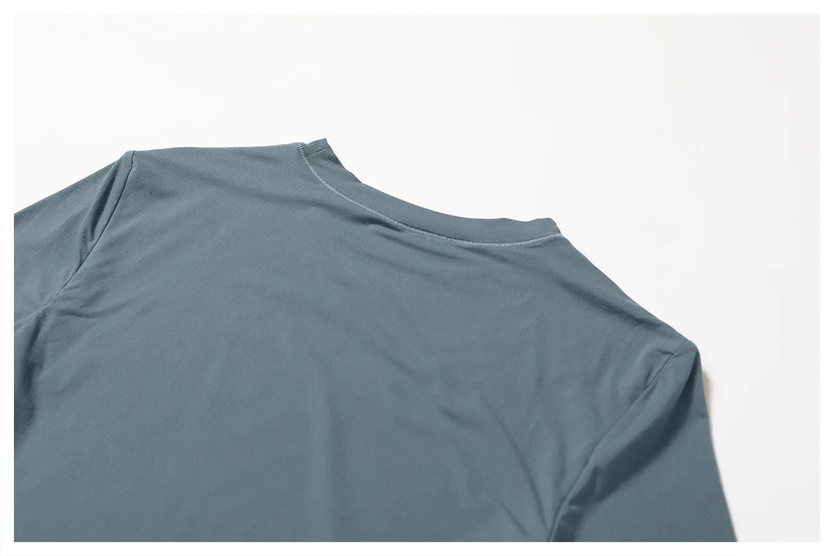 Back view of Xooie Fit women's fitted long-sleeve shirt in soft fabric with a classic neckline