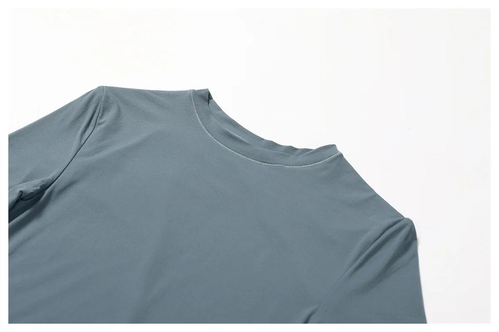 Xooie Fit women's fitted long-sleeve shirt in soft blue with a comfortable neckline