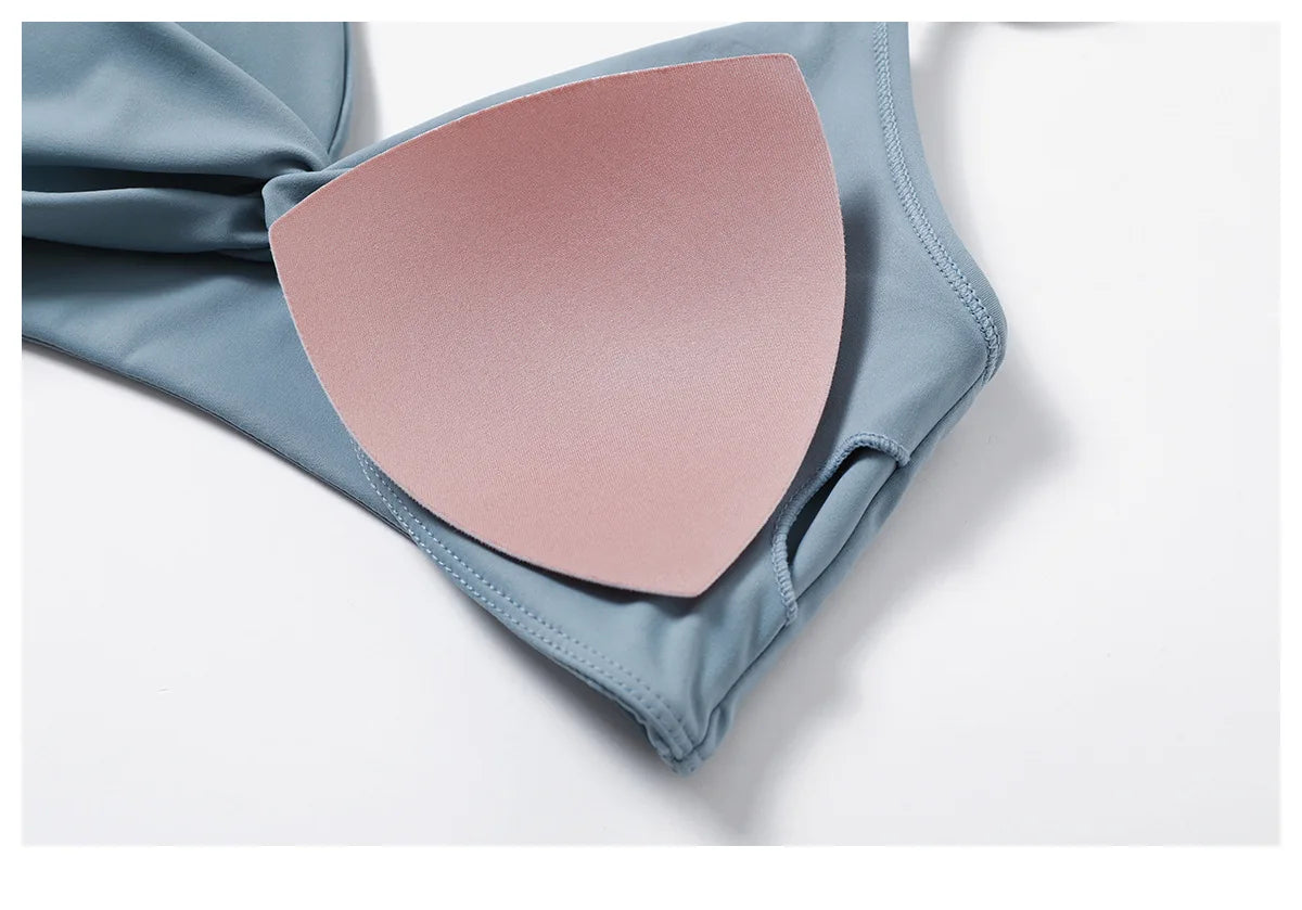 Close-up of a blue women's two-piece workout set showing the bra cup padding detail
