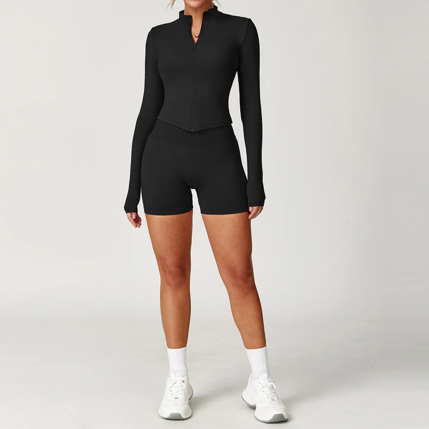 Black fitted zip jacket and matching active shorts set, front view