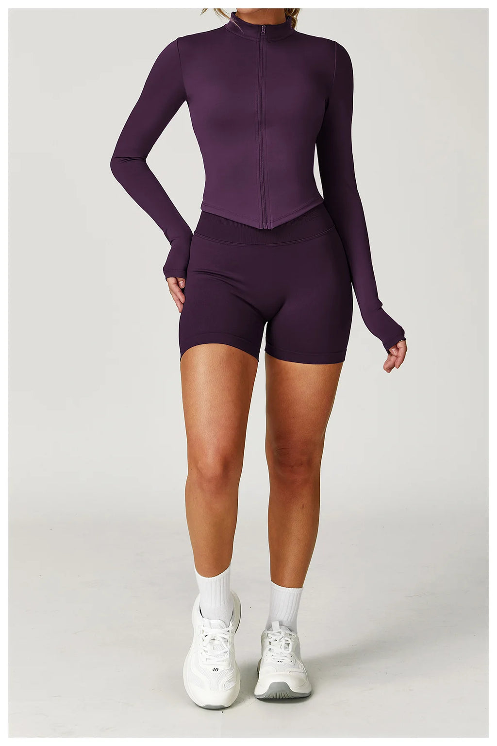Plum purple fitted zip jacket and matching active shorts set, long sleeves, high neck