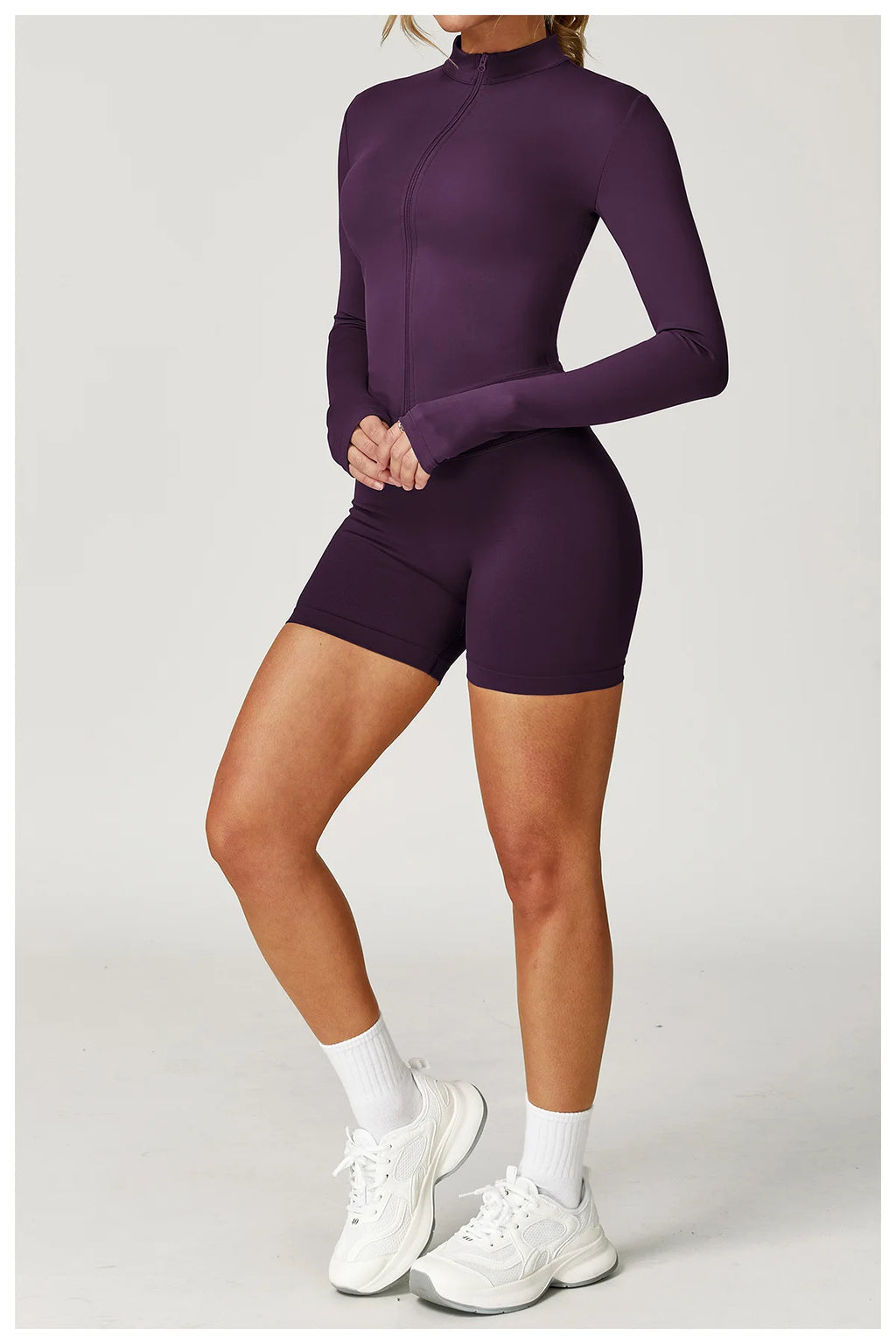 Plum purple zip-up fitted jacket with matching high-waist active shorts, full set view