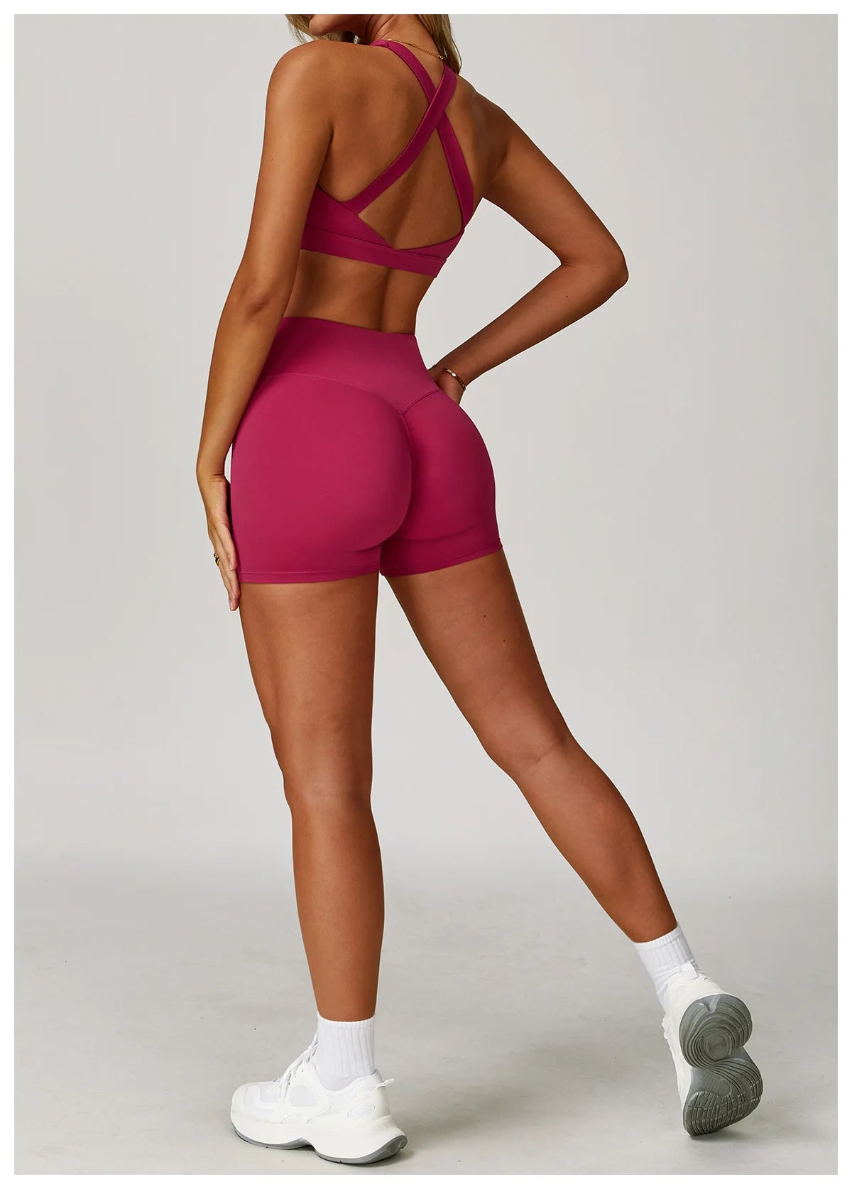 Back view of X-back sports bra and shorts set in pink, designed for comfort and movement.