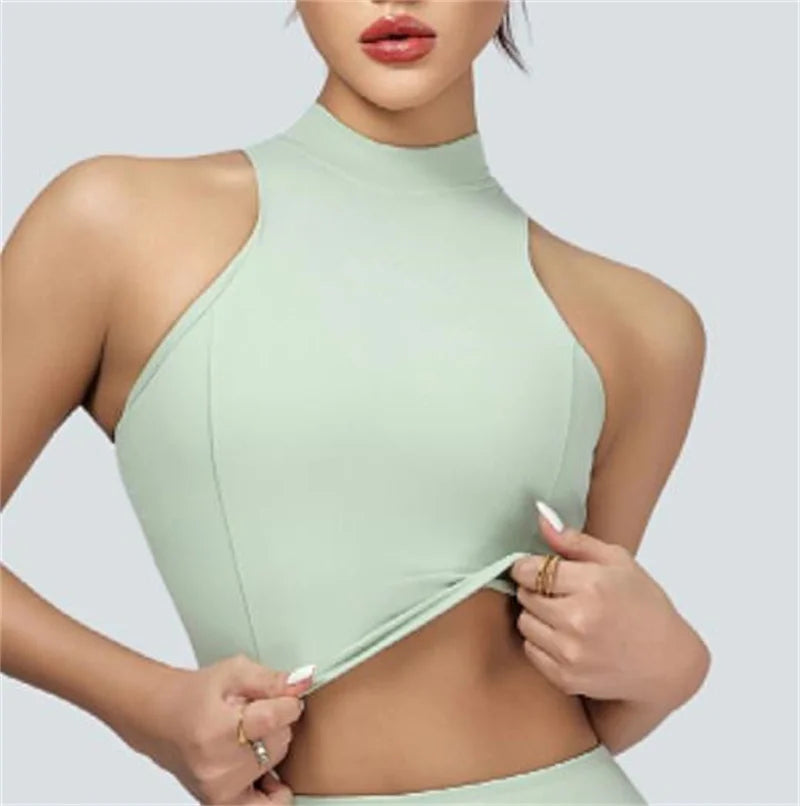 Xooie Fit vest crop top and skort set featuring a sleeveless high-neck crop top in light green